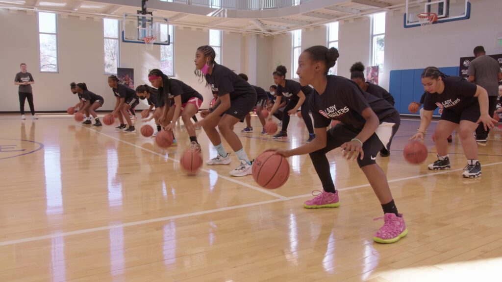 GIRLS AT LADY BALLERS CLINIC STRENGTHEN SKILLS AND ARE COACHED BY HARLEM GLOBETROTTERS ‘MIGHTY ’ MIA